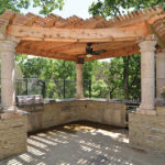 A custom pergola over a paved patio.