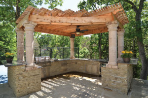 A custom pergola over a paved patio.