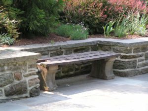 An attractive retaining wall with matching bench.