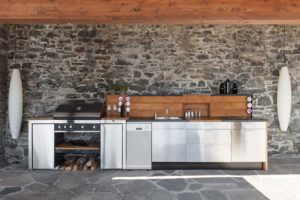 An outdoor kitchen with many modern conveniences.