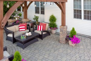 An attractive paved patio with furniture.