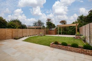 A spacious backyard with a wooden pergola.