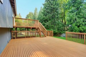 Expansive multi-level wood deck on a gray house