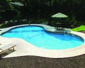 Inground pool surrounded by lounge furniture